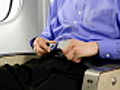 Airplane Passenger Buckling His Seatbelt | BahVideo.com