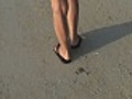 Walking along the beach close-up on legs and feet | BahVideo.com