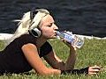 Beautiful Blonde With Headphones Outdoors Stock Footage | BahVideo.com