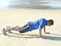 Runner doing push-ups on a beach | BahVideo.com