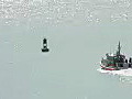 Royalty Free Stock Video HD Footage US Coast Guard Patrol Boat Heads Out to Sea at the Harbor at Honolulu Hawaii | BahVideo.com