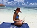 Beautiful woman working on laptop near water at Maldives | BahVideo.com