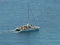 Royalty Free Stock Video SD Footage Zoom Out From Catamaran Leaving Lagoon on North Shore Coastline in Maui Hawaii | BahVideo.com