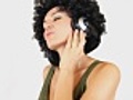 Woman with afro listening to music isolated  | BahVideo.com
