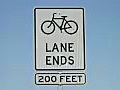 Royalty Free Stock Video HD Footage Bike Lane Ends 200 Feet Warning Road Sign | BahVideo.com