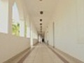 Woman walking through long corridor of an  | BahVideo.com