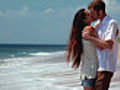 Happy couple kissing on beach  | BahVideo.com