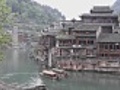 Chinese boats rowing abreast hanging feet hut and pagoda | BahVideo.com