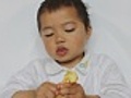 kid squeezing orange pulp saliva slavering down  | BahVideo.com