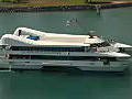 Royalty Free Stock Video HD Footage Small Cruise Ship Approaches the Port of Honolulu and Aloha Tower in Hawaii | BahVideo.com