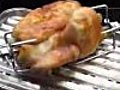 Grilling a chicken on a barbecook Banika | BahVideo.com