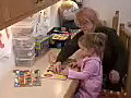 Royalty Free Stock Video HD Footage Adult and Child Playing With Puzzle Toy in a Library on a Winters Day | BahVideo.com