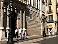 Royalty Free Stock Video HD Footage Pan Down to Police Officer and Building in a Plaza in Barcelona Spain | BahVideo.com