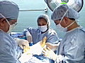 Royalty Free Stock Video SD Footage Zoom Out From Nurse to Doctor Completing Surgery on Patient s Foot | BahVideo.com