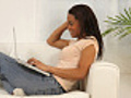 Woman sitting on couch with laptop computer | BahVideo.com