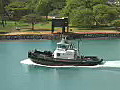 Royalty Free Stock Video HD Footage Tugboat Leaves the Harbor in Honolulu Hawaii | BahVideo.com